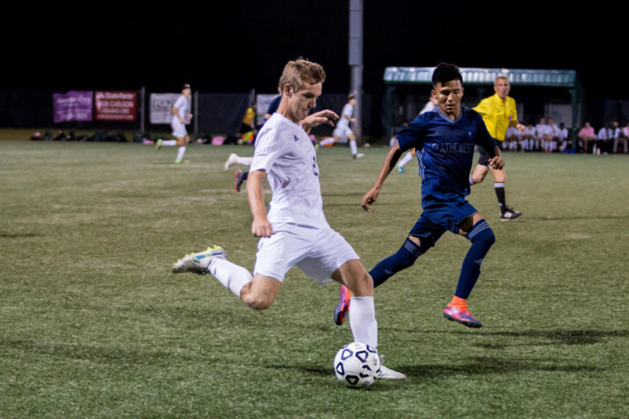 With determination, senior Nick Howard kicks the ball down field. The firebirds won 3-0 against Olathe West.