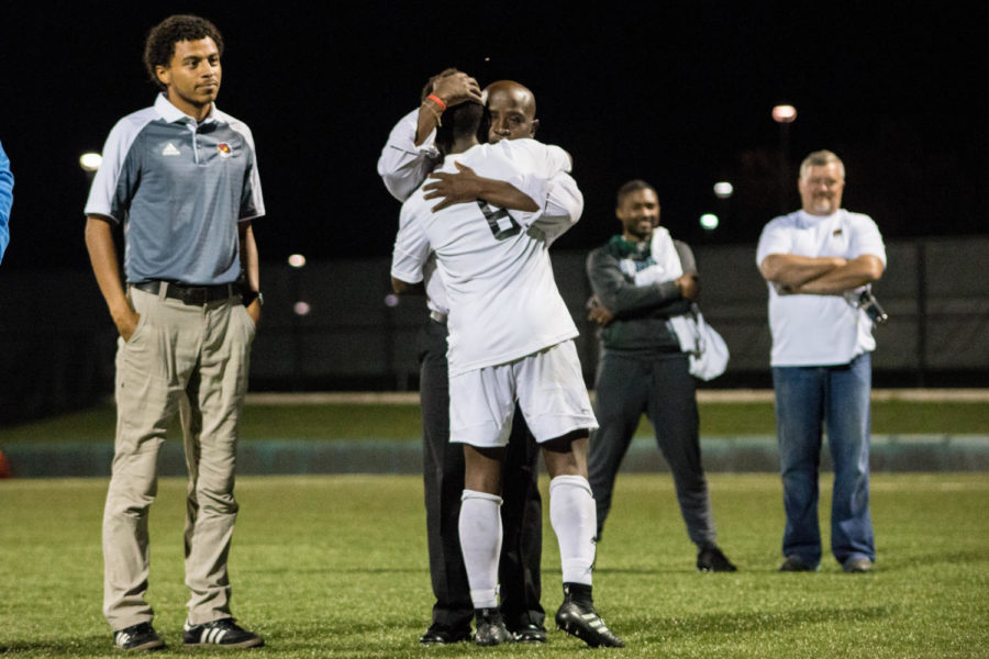 After being recognized by his team members, senior Mburu Nganga gets hugged by Coach Barah. Barah gave each senior a hug. 