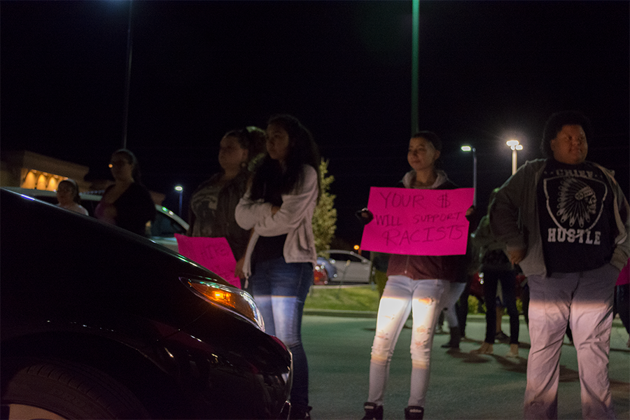 Sophomore Ashton Mcknight and fellow protestors block a car from entering the Burger King parking lot. The car eventually forced its way through, but left immediately afterwards.