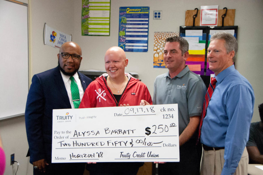 Standing with superintendent Anthony Lewis, principal Myron Graber, and Truity Bank representative Tim Mock, math teacher Alyssa Barratt recieves a check for two hundred and fifty dollars.