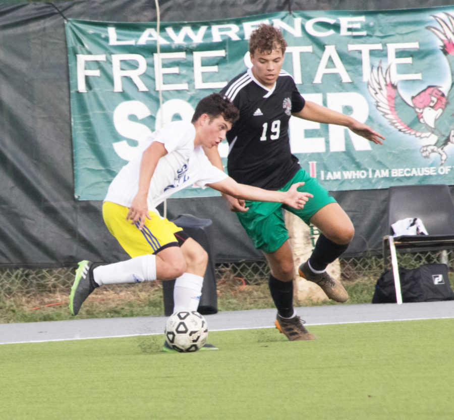 Trying to prevent his opponent from scoring, senior Everett Waechter moves in front of the balls path. It was a good step forward for the team, said Waechter. Waechter plays as a defender and sometimes plays in the forward position. 