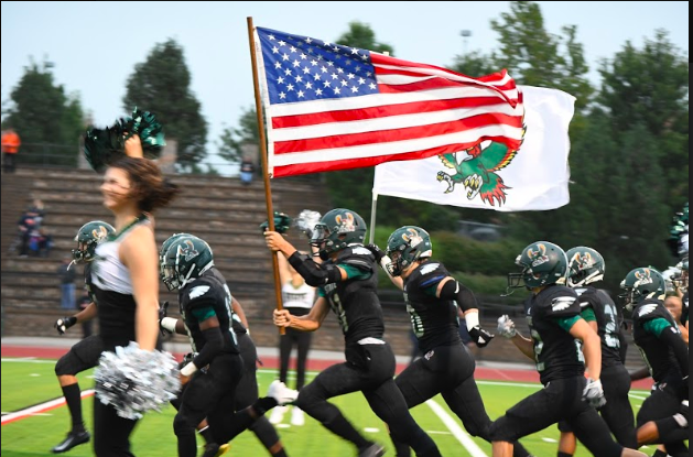 Cole Phillips sprints through the first home opener of the season. I was just thinking its our home opener, this is crazy... [the] stands are packed and I better not drop this flag, Phillips said. 