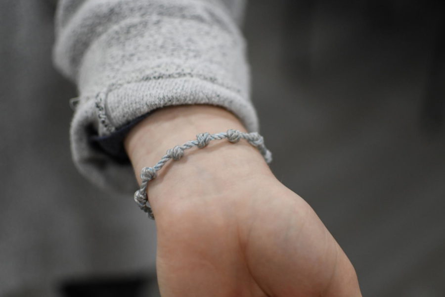 As an expression of her individual faith, Sara Pavlyak wears a rosary bracelet representing her Christian values. 