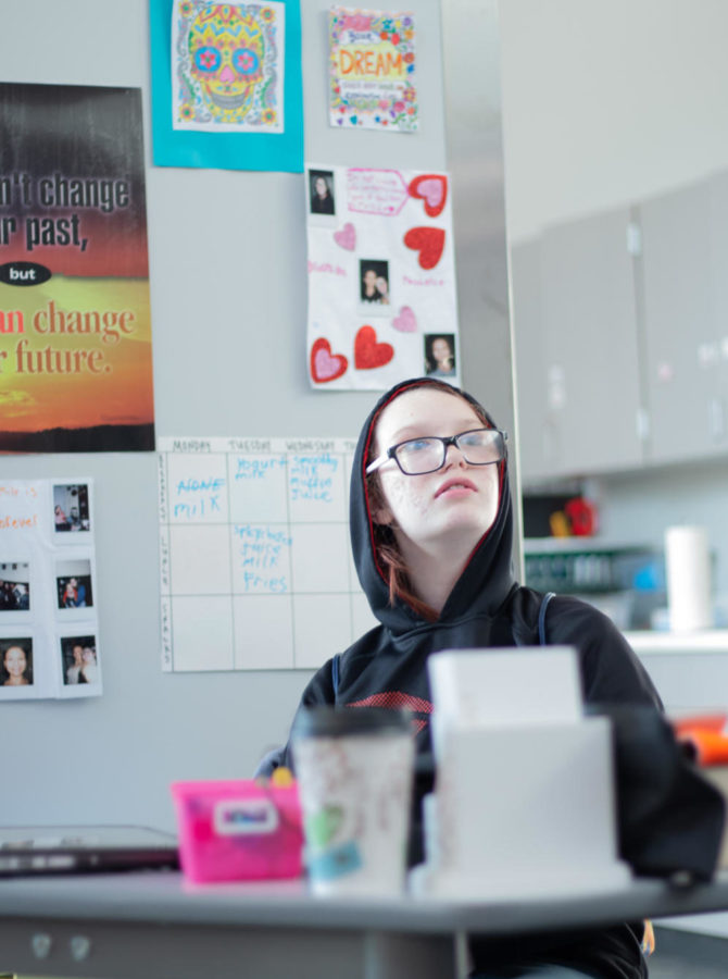 Freshman Kaydence Bennett sits quietly in her new workspace. Initially the pillars in the middle of the room presented a challenge, but teachers found ways to utilize the space to fit the student’s needs.  “That pilar became a good background for [Bennett] to protect her from sound coming from the back,” SpEd teacher Marie Wheeler said. 