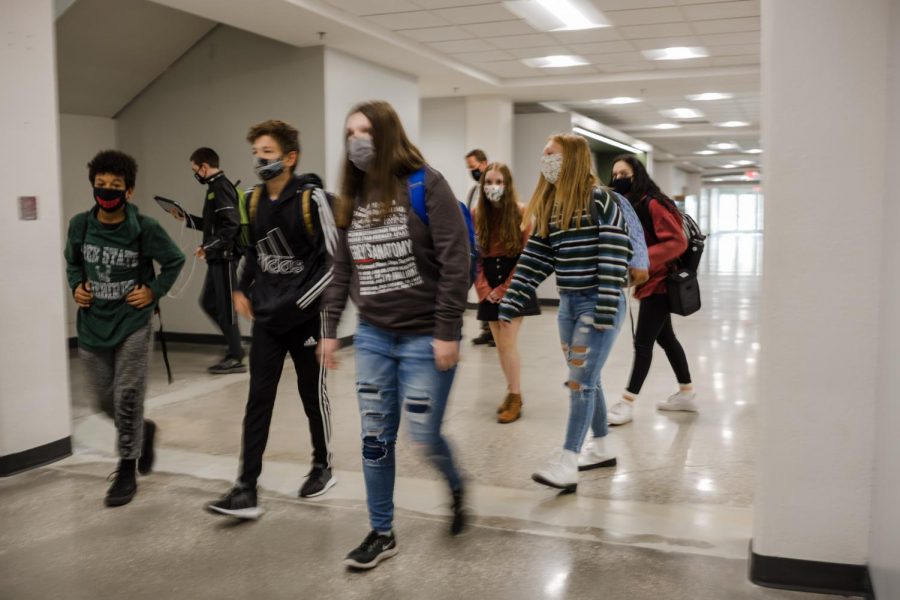 Walking through the halls, a group of students heads to their next class. The hybrid plan began in late October, and continues phasing-in to allow more students to attend in-person classes. 