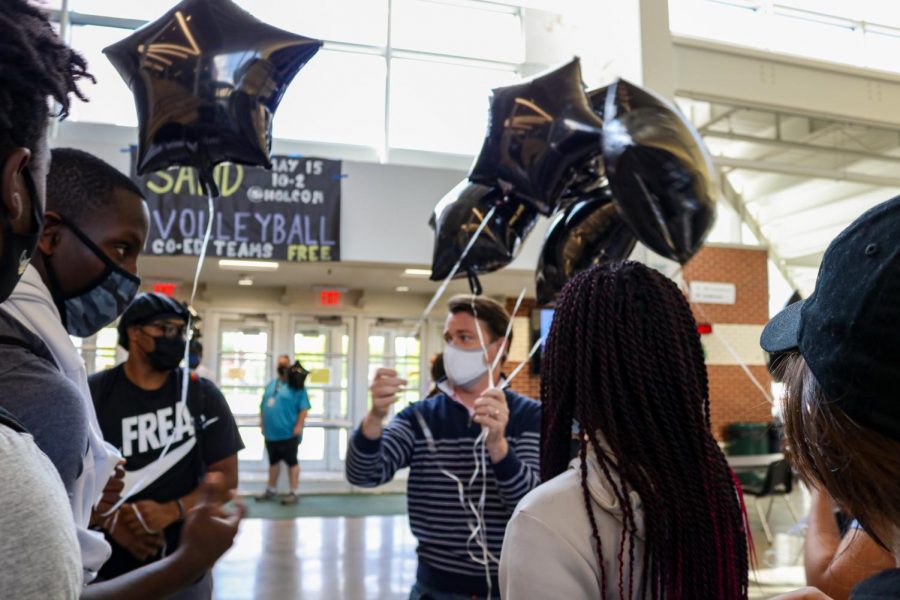 Staff and students prepare to release balloons in honor of Dee Kemp