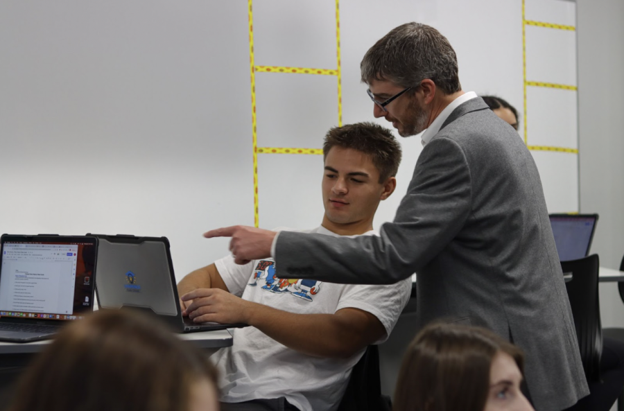 Helping senior Talyn Nichols, social studies teacher Blake Swenson juggles the workload of a teacher. With recent budget concerns, Swenson stayed frozen at step 4 on the salary schedule rather than moving to step 6 to increase his base pay this year.