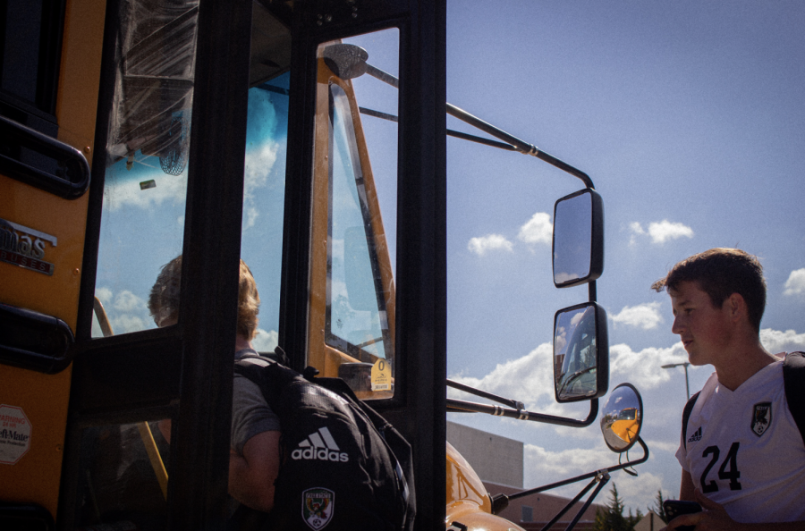 Leaving six hours prior to game time, Senior Varsity player, Spencer Bentley, loads the cooler onto the bus. Proper amounts of food and water are critical for the players to maintain their energy during the extended wait. 