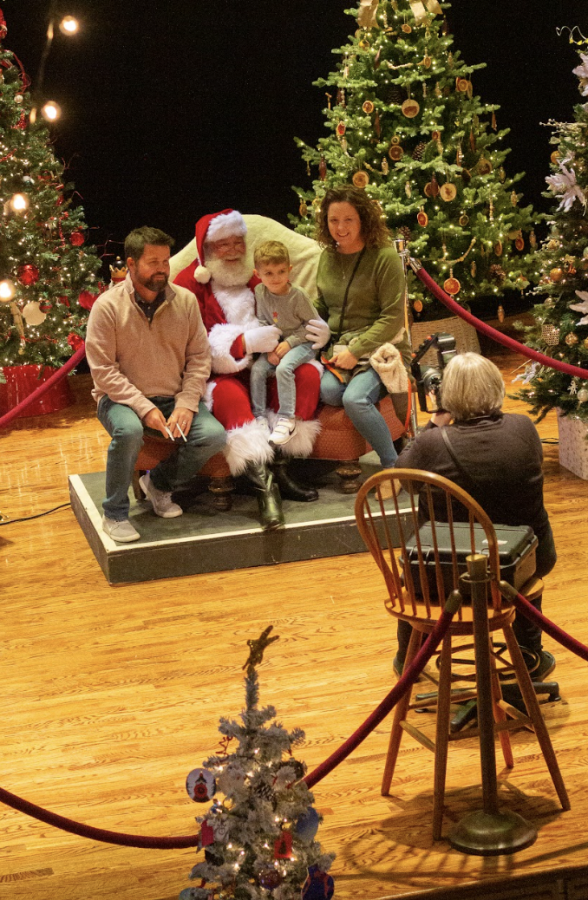 Families pose with Santa Claus during Festival of Trees. 