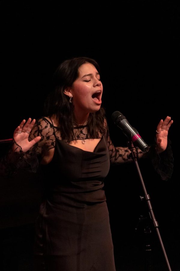 Hands in the air, junior Mary Ramirez sings “No One Else” by Dave Malloy. Although the performance was intimidating, Ramirez enjoyed the professionalism and rewarding feeling of the event. “Its a perfect opportunity to do the things you love alongside super talented students,” Ramirez said. 