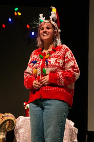 Senior Lily Otter smiles while performing on stage at an improvisation show. Otter and her fellow teammates prepared for the festival by using their shows in the black box theatre as a learning experience