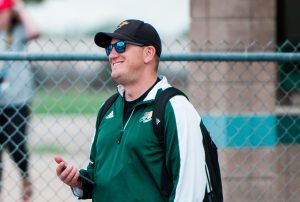 Leitel smiles while watching the girls tennis team warm up before a match.