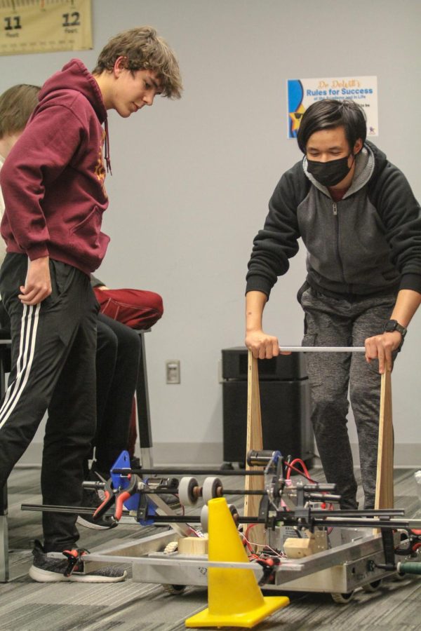 Juniors Peter Burdick from Free State and Sophomore Sean Dixon from Lawrence High, members of the technical team on Team STEAM 5119, test their robot to see if it can pick up a traffic cone.