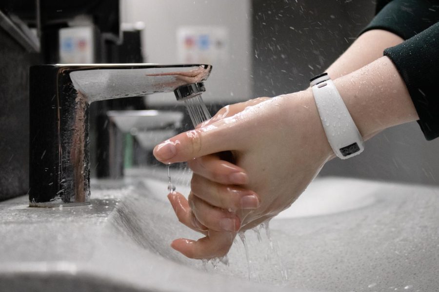 In order to prevent the spread of disease, sophomore Lola Stuhlsatz washes her hands. Stuhlsatz started taking extra precautions to avoid illness after contracting COVID-19 ahead of finals. “Hand washing is very important, you have no idea what was on the surface you just touched,” Stuhlsatz said.   