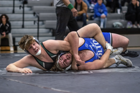 Senior Matthew Marcum, successfully pins down his opponent from Holton, winning the match on Dec. 1. Achieving the 100 Win Club was just one of Marcum’s goals coming into his senior year. “Most of my goals are pending with Regionals and State still awaiting,” Marcum said. 