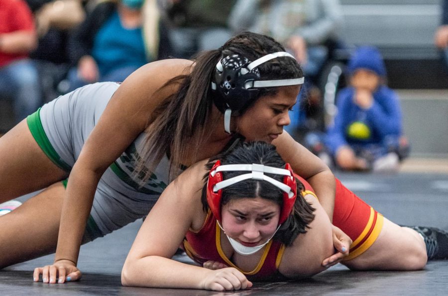 Pinning down her opponent, sophomore Dajiah Preston wins her match against Lawrence High School. Between wrestling last year and this year, Preston has found that putting yourself out there makes it even more enjoyable. “If something sounds fun to you, you can go out and do it and be the best at what you’re doing,” Preston said.