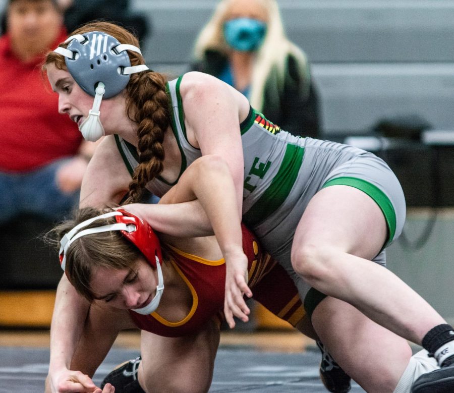 Going for the pin, freshman Ava Corbin takes down her opponent. Although unsure at the beginning of her season, Corbin has grown to love the sport. “My friends were doing it and I joined as a joke,” Corbin said. “But then I started to really love it as a sport. [I’m] definitely going to continue to do it next year and the years to come.”