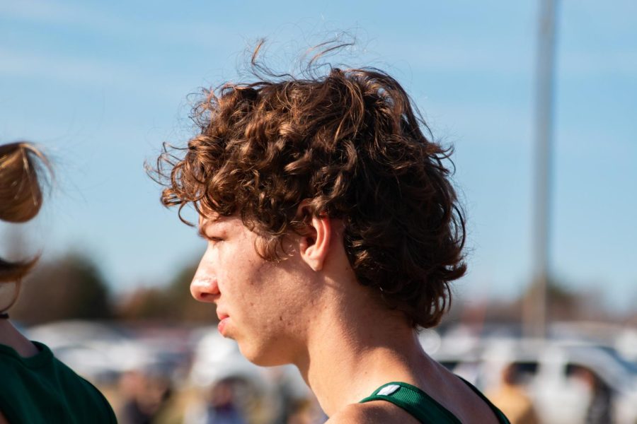 Focusing on the race, junior Zach Hansen Terry gets prepared for the 5k competition. Hansen Terry enjoyed the camaraderie that was present within the boys varsity team. My favorite pre-race tradition is running the course before with my team, Hansen Terry said. 