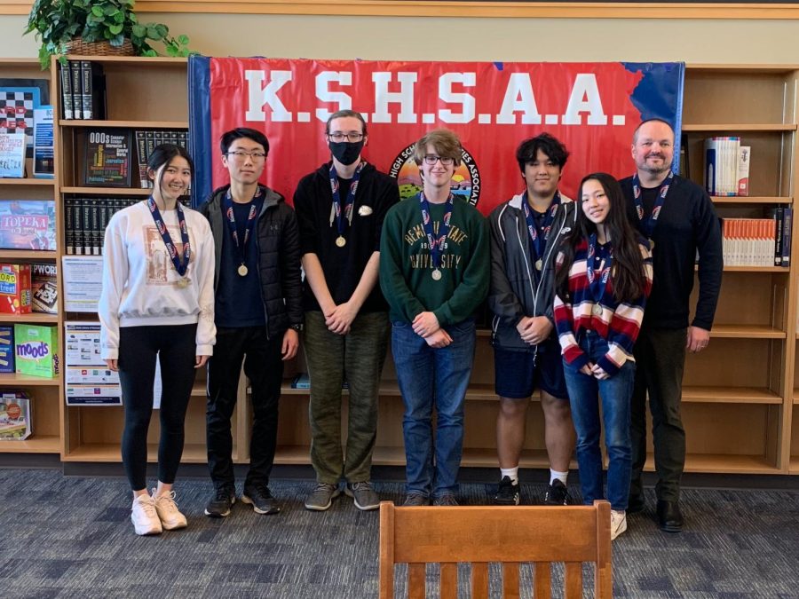 The+Scholar%E2%80%99s+Bowl+team+shows+off+their+fourth+place+medals+at+the+state+competition+on+Feb.+11.+As+coach+of+the+team%2C+Oather+Strawderman+enjoyed+seeing+the+students+be+successful+and+take+pride+in+their+accomplishments.+%E2%80%9CThey+should+be+really+proud+of+themselves+because+the+6A+Scholar%E2%80%99s+Bowl+is+a+really+tough%2C+competitive+environment%2C%E2%80%9D+Strawderman+said.+%E2%80%9CThey+did+really+well.%E2%80%9D