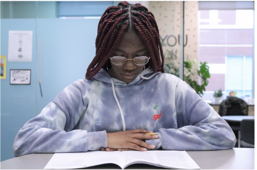 Junior Nomso Enyinnaya reads through a per-test packet for the ACT exam. Enyinnaya had taken a class during her first and now second semester that helped her to study and be prepared for the ACT. “The ACT is practically a reflection on how youre doing in school, it can really help the teachers with placing you in classes with people on the same level as you so you dont feel out of place.” Enyinnaya said. 