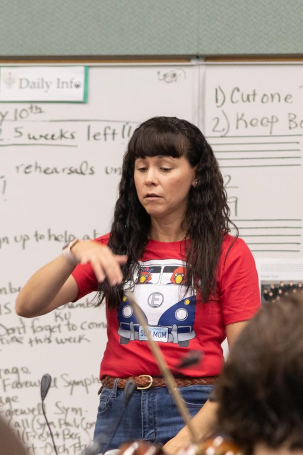 Taking the podium, orchestra director Judy Erpelding conducts the class. Erpelding has expressed a lot of sympathy towards the students in the arts program due to district cuts. “We have just as many students in the arts as we do sports, I love sports,” Erpelding said. “My children are all athletes, my husband is a coach, it’s a huge part of my life. I believe very strongly that the performing arts and fine arts are just as important to students.”