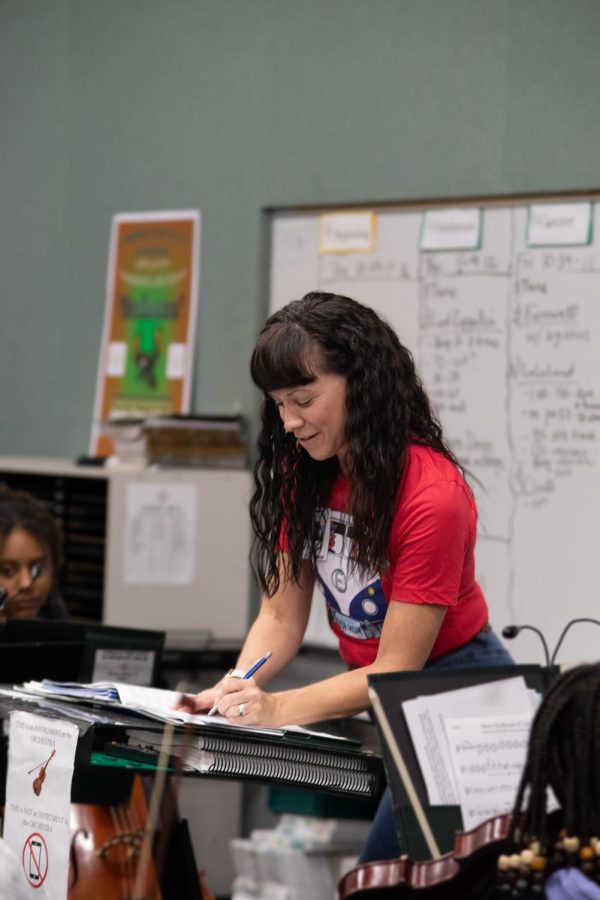 After receiving advice from her students, orchestra director Judy Erpelding marks her music. Although the director normally makes the artistic decisions, Erpelding will often consult her students and hear their opinions on what sounds good and what they should try out. “[The students] are the heart of the program, not me,” Erpelding said. “I know they will carry that on and I will miss them. Making great music with them, being able to challenge them, taking their inspiration.”