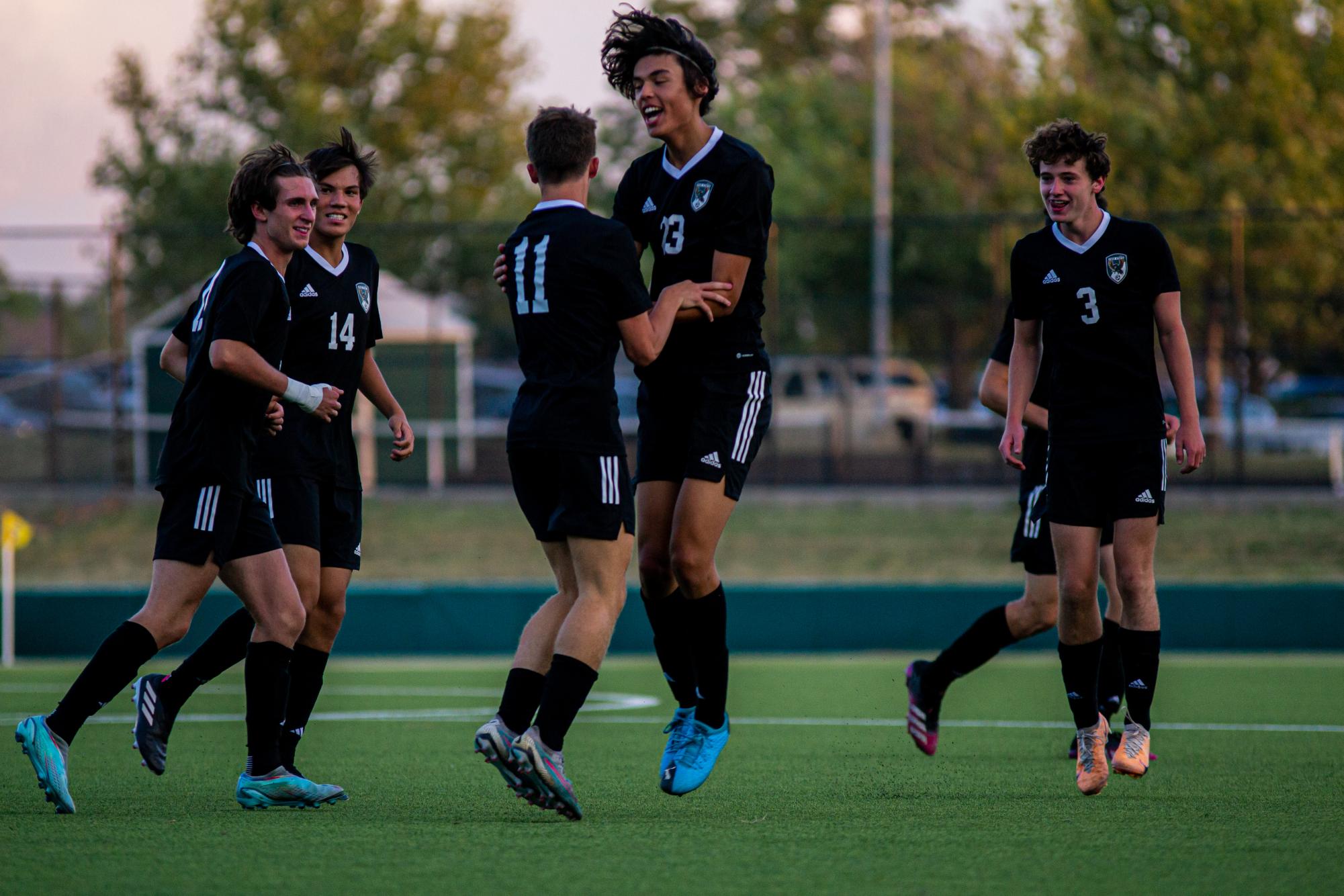 After scoring a goal, the boys varsity soccer team celebrates with each other. They beat Shawnee Heights 5-0 on Tuesday, Sep. 5. 
