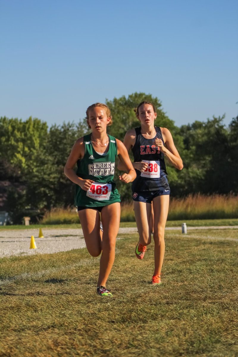 Sophomore+Addy+Tenbrink+passes+an+opponent+from+Olathe+East.+In+her+second+year+on+the+team%2C+Tenbrink+is+a+regular+runner+on+Varsity.+