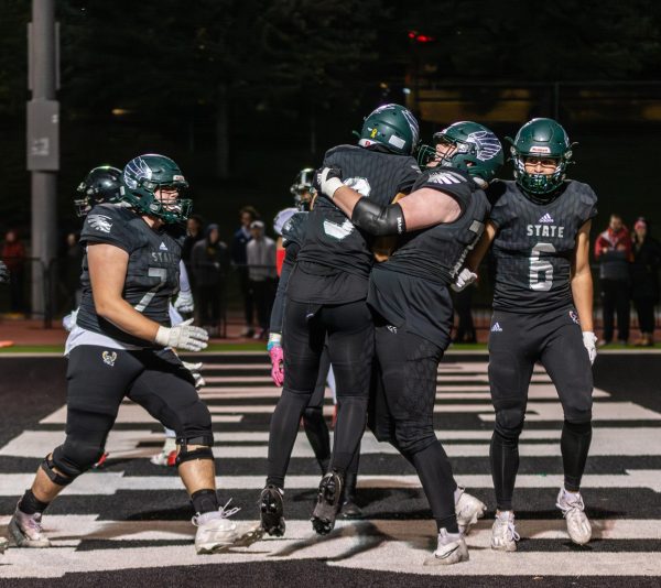 Senior Hank Fuchs hugs junior Bralin Preston after Preston scores a touchdown at the City Showdown on Oct 13. 
