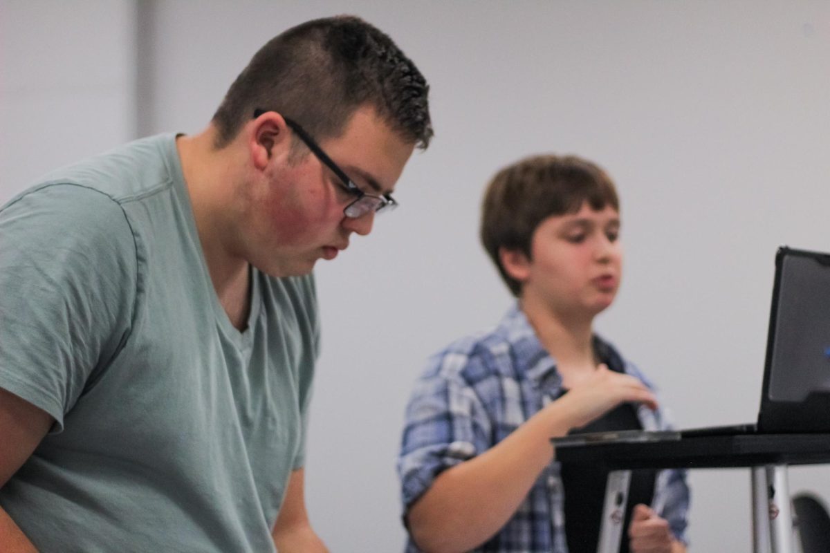 Junior Ben Stammeyer reads through his notes on the argument while his opponent presents their case. 