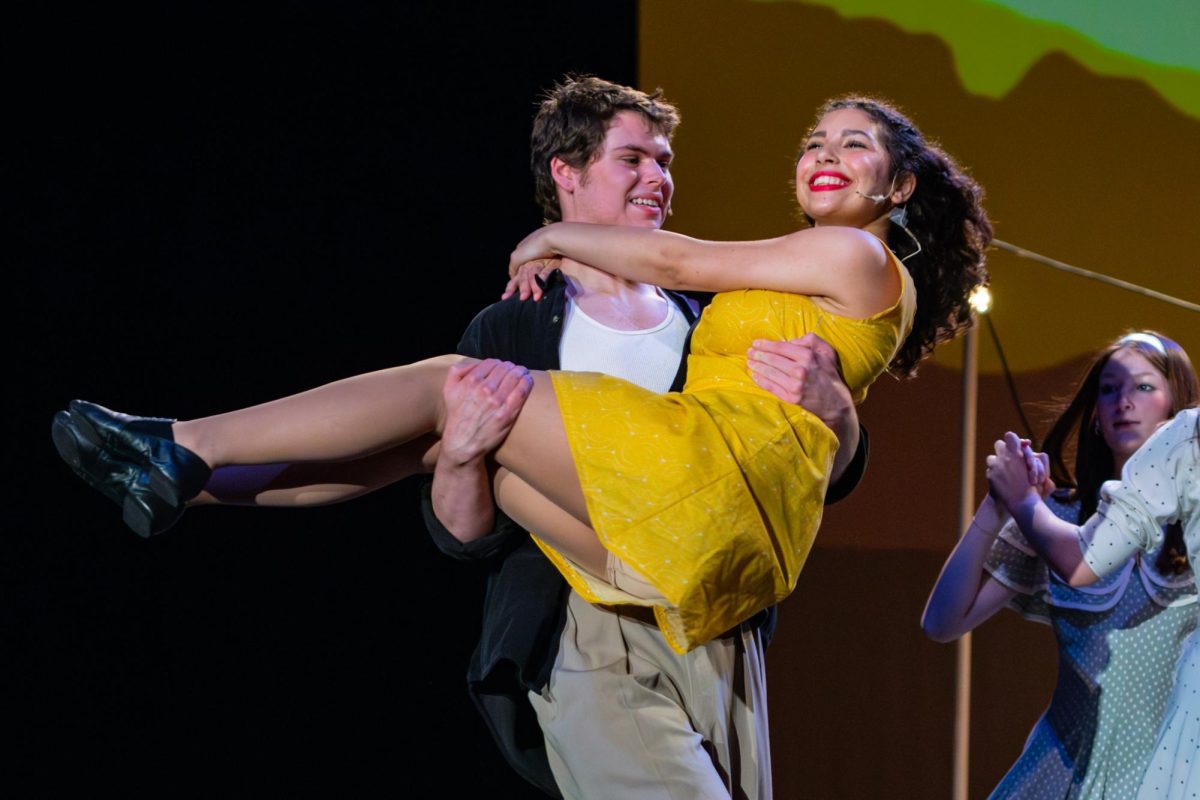 Spinning around the stage, junior Kiefer Bullock lifts senior Jazzlyn Fowler.