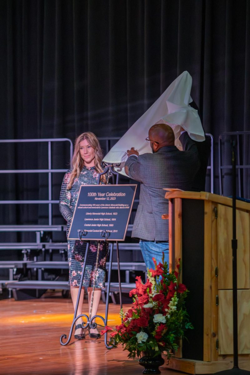 Lifting a sheet, Liberty Memorial Central Middle School principal Jennifer Schmitt and superintendent Dr. Anthony Lewis unveiled the plaque celebrating 100 years of the school. Both a commemoration of the day and the varying names of the school throughout the years can be found on the plaque.