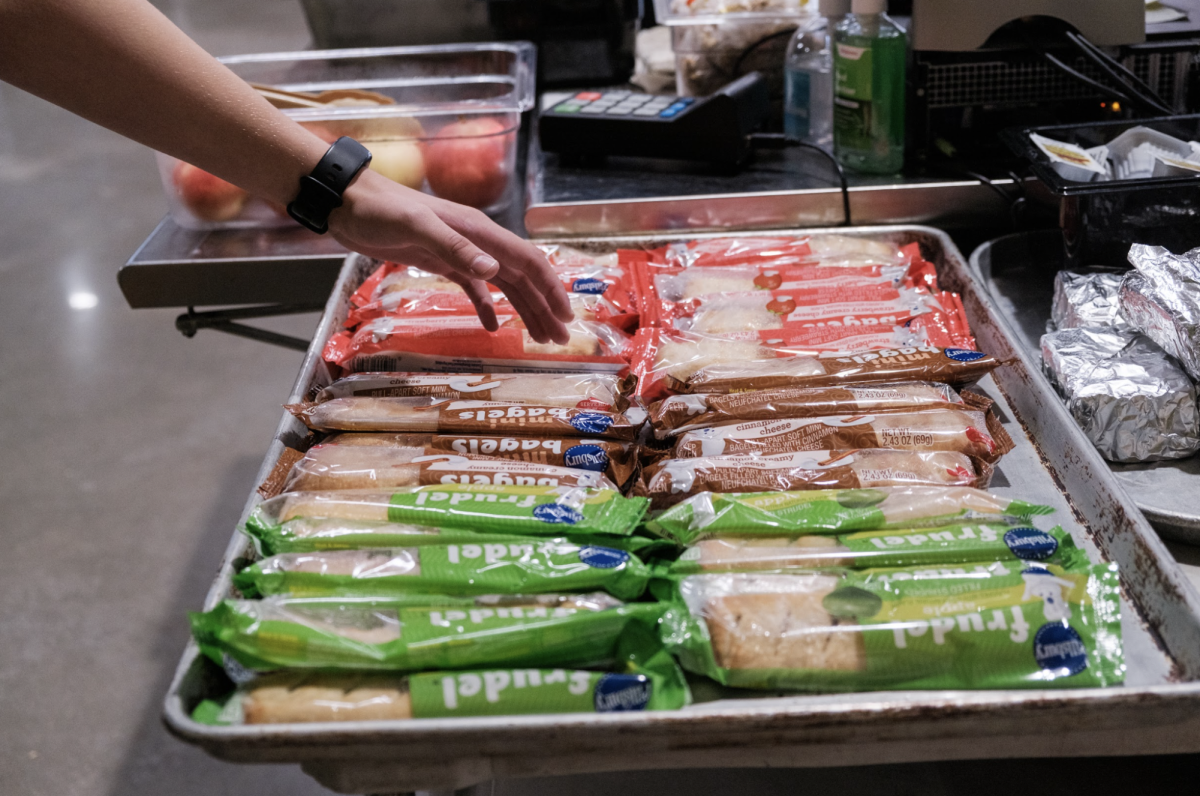 Reaching out, a student is shown purchasing a breakfast bar from second chance breakfast. The newly implemented second chance breakfast program was put on hold for Nov. 10 and Nov. 13 after a physical altercation erupted during second chance breakfast.