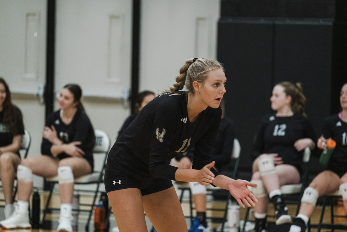  Clapping her hands, senior Fiona Van Dyke watches the ball at a home game on Aug. 31.