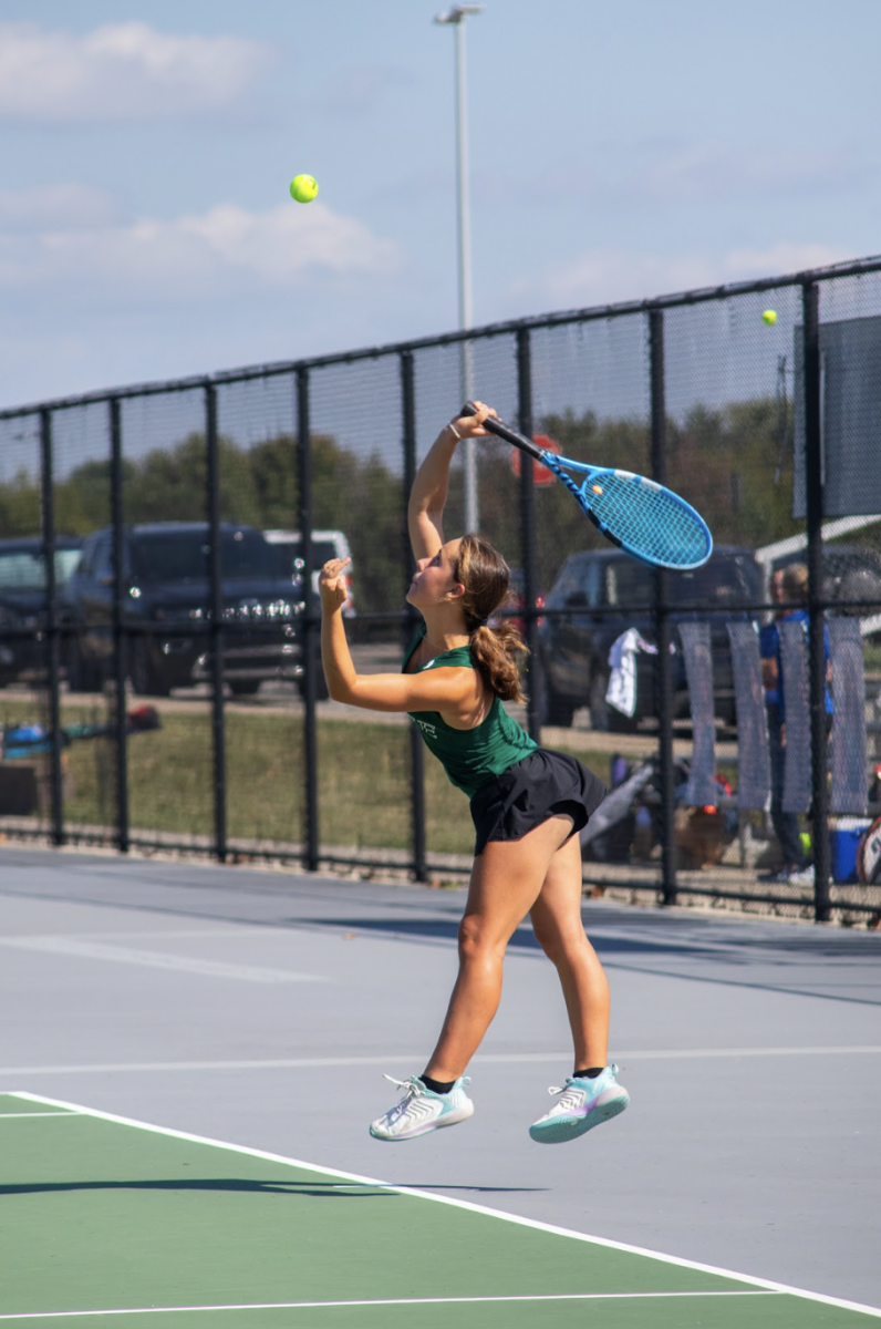  In the air, sophomore Cami Lee hits the ball at a home meet on Sept. 20.
