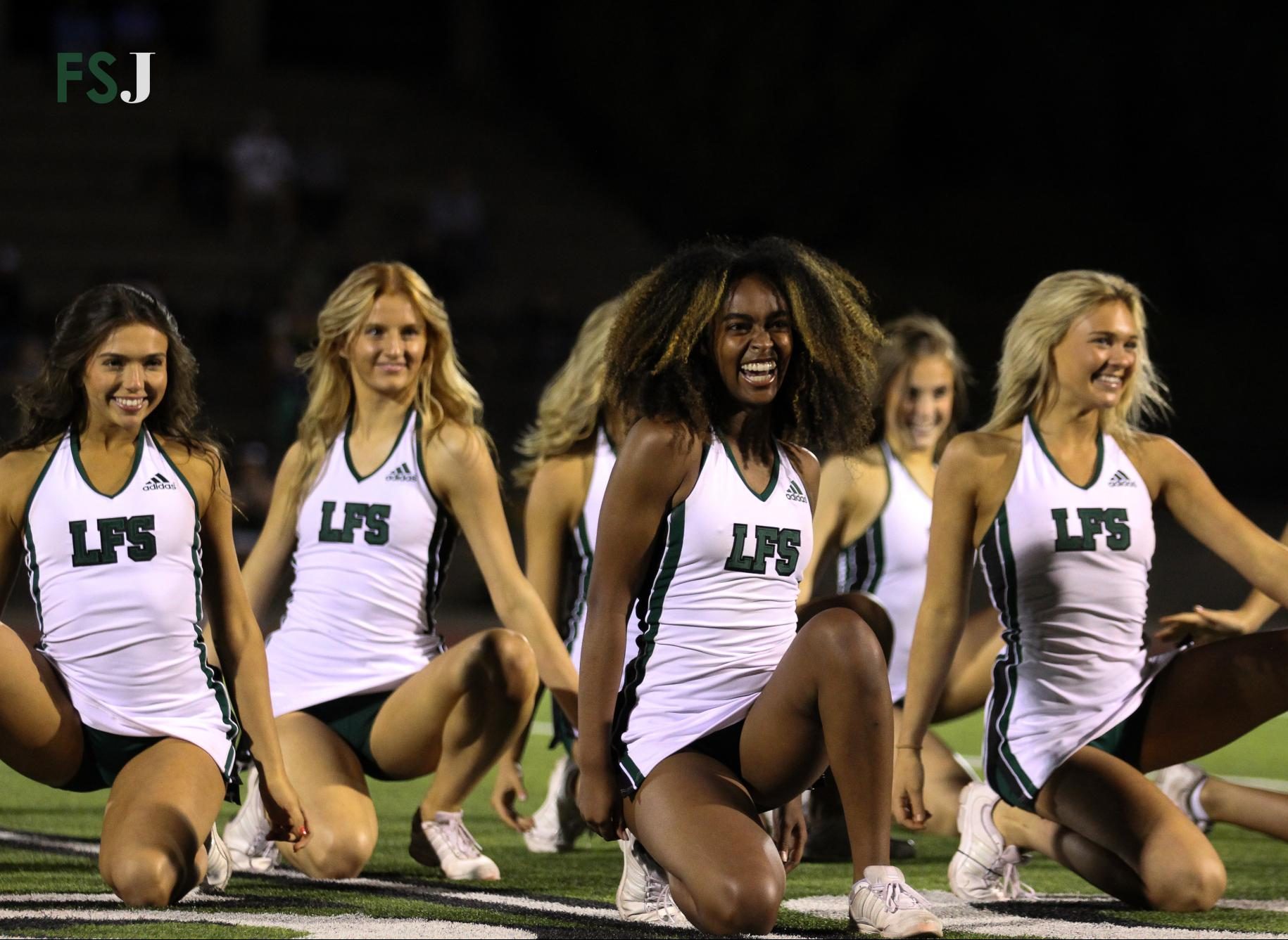 Alumni Marina Kimzey, Angel Waller and Alexa Beaty perform at half time during the 2022 football season. Past their high school career, the three have moved on to perform at a collegiate level.