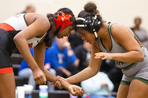 Taking hold of an opponent, junior Daijah Preston begins to wrestle. As one of the Girls Wrestling captains, Preston played a large role in motivating the team. 
