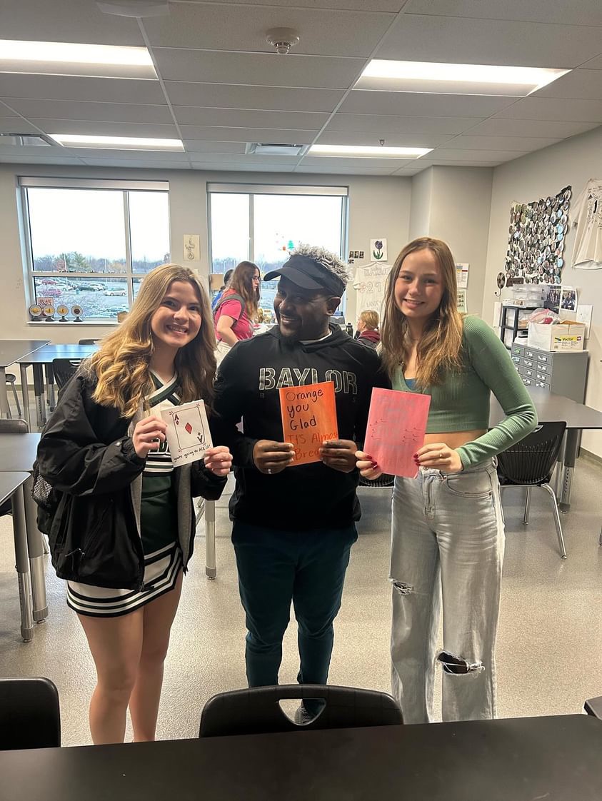 Juniors Vivi Riffel, Dru White and club sponsor Kelly Barah pose with cards made by Sending Luv Club. 