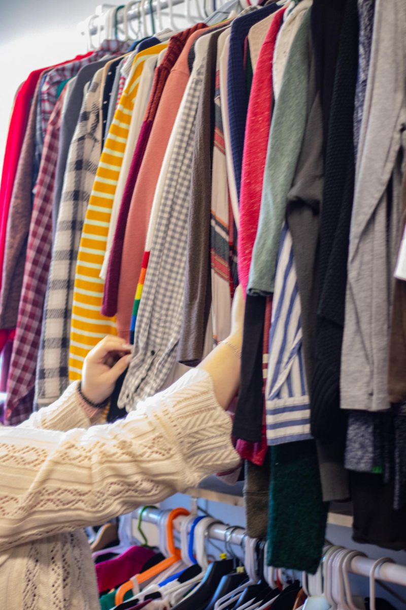 A student looks through the clothing resources available in the Charles Thomas Clothing Closet. 
