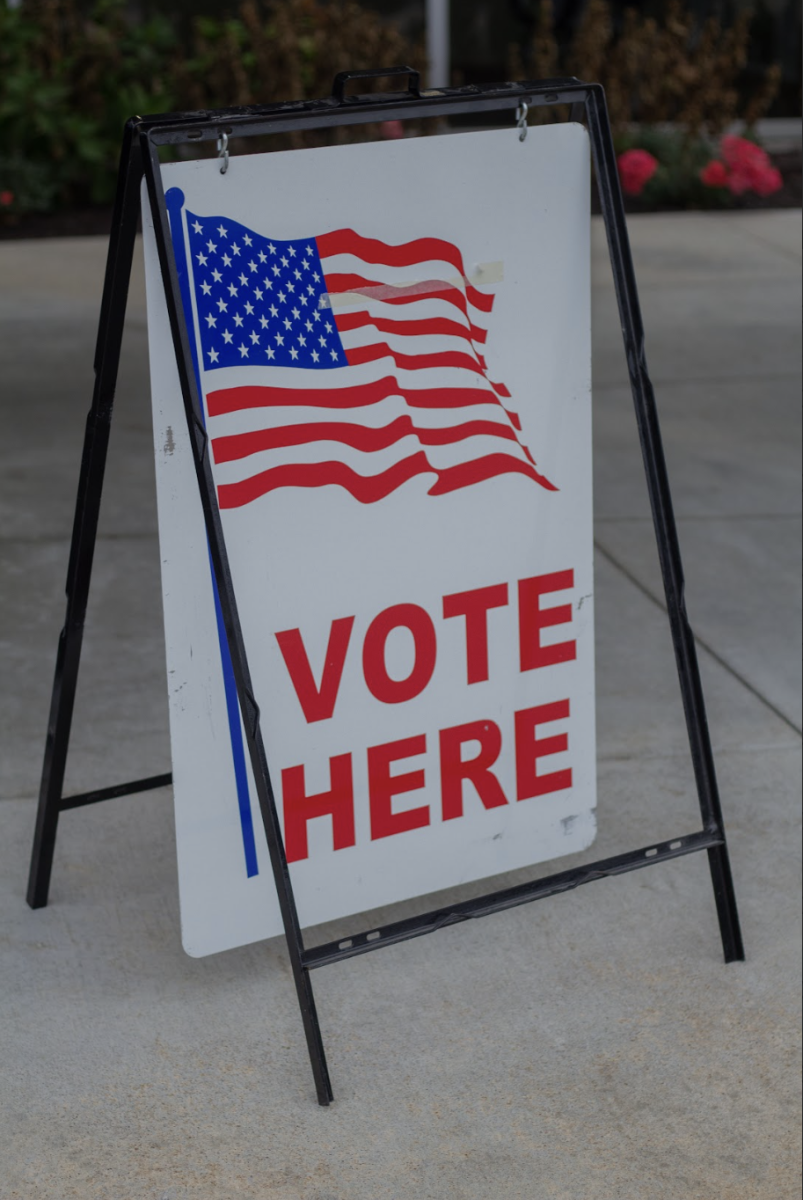 A sign outside a polling station indicates the voting location for an election.