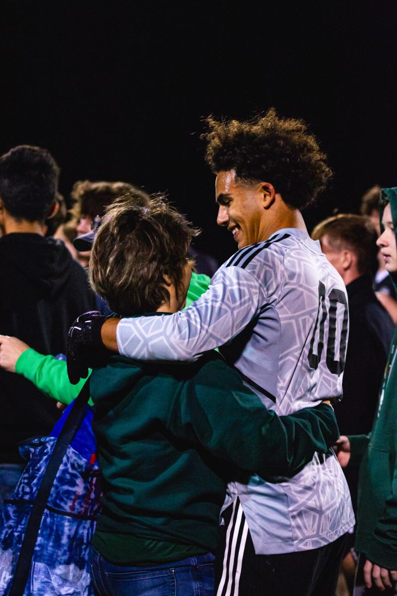 Celebrating the victory of the game, junior Yusef Iskandrani hugs his mother. Iskandrani played throughout the varsity soccer season while observing Ramadan. The most challenging aspect of Ramadan is being really thirsty. I cramp so much during the games because my muscles have no water or nutrition to last me my whole game. Its extremely challenging but I know god will help me through out the way.