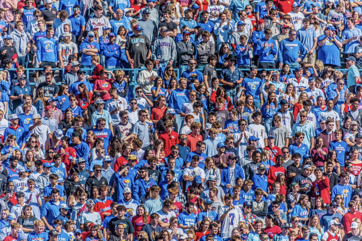 University of Kansas [KU] students stand in the student section of David Booth Kansas Memorial Stadium as they spectate a KU football game. This year as the stadium is undergoing construction, KU football is moving to the Chiefs Stadium for the 2024-2025 season.
