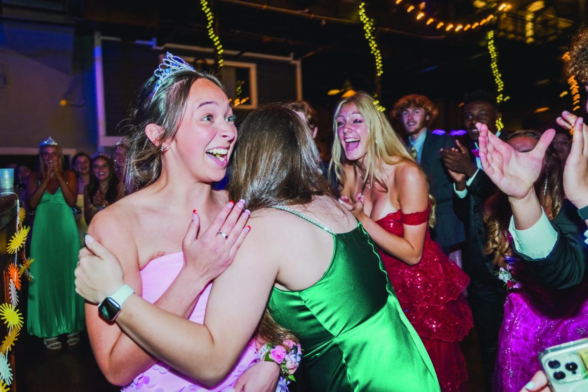 In shock, senior Tehya Jacobs receives a hug from Lawrence High School senior Aubrie Magnuson after Jacobs is announced as Prom Royalty alongside senior Nolan Craig.