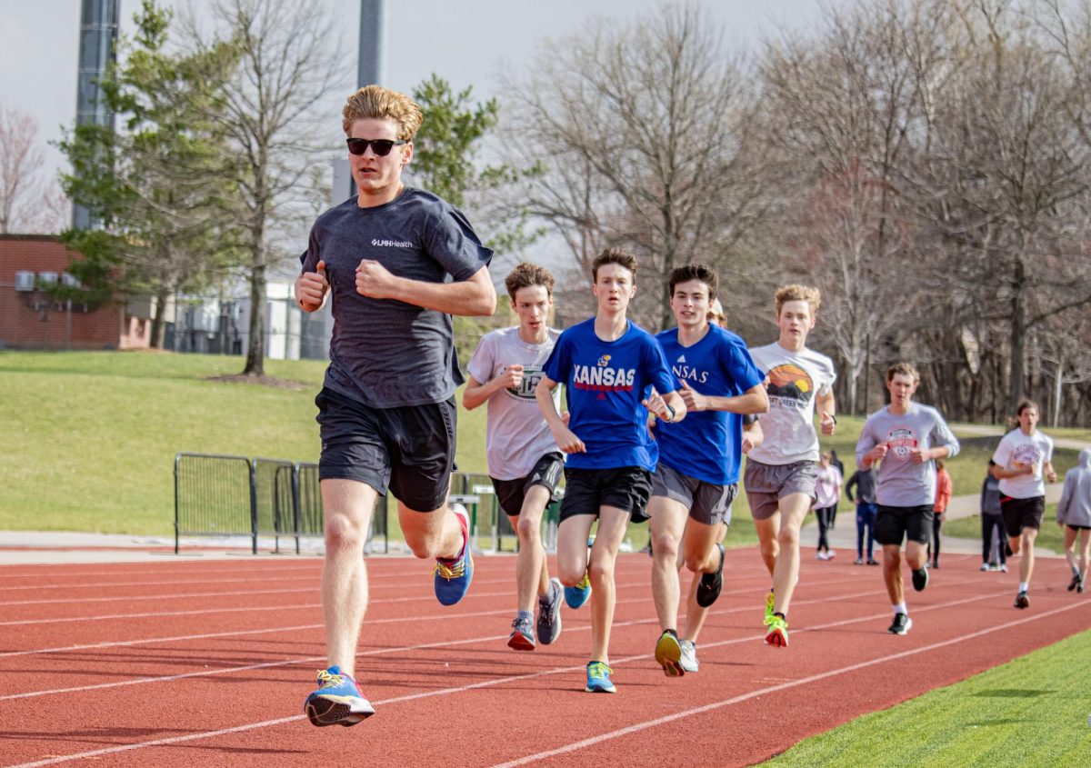 Senior Jake Loos and other members of the track team run during practice. Archived photo from Addie Driscoll.