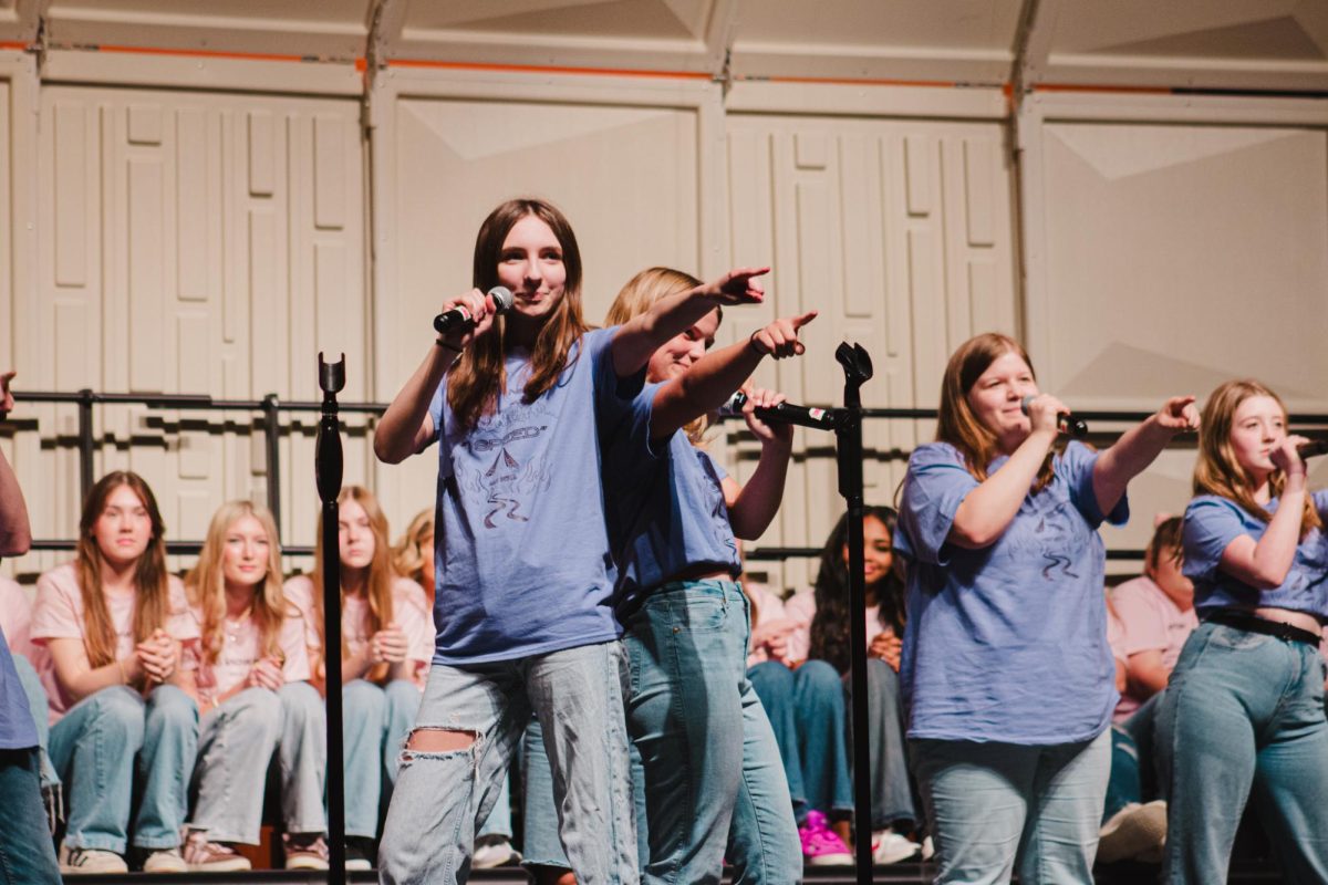 Singing Jackson 5's "I Want You back," Freshman Penelope All points to the audience.