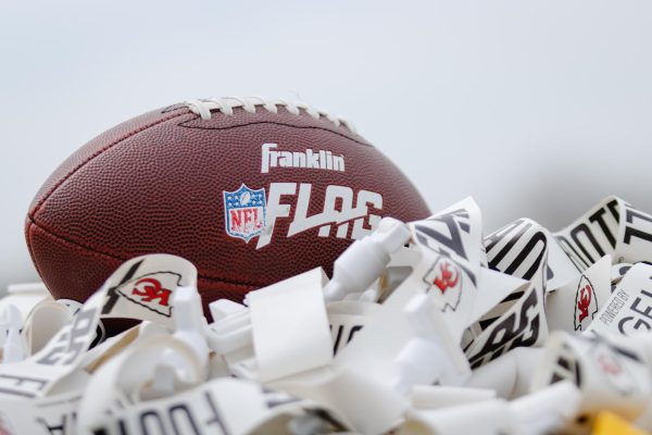 A football rests atop a pile of belts and flags, provided by the KC Chiefs for the flag football clinic on April 9, 2025