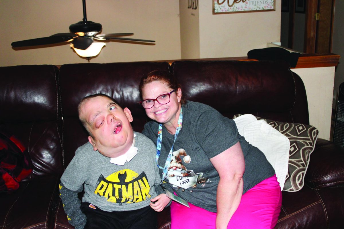 Sitting together, Frankie and his nurse, Julie Govier, smile for the camera. 