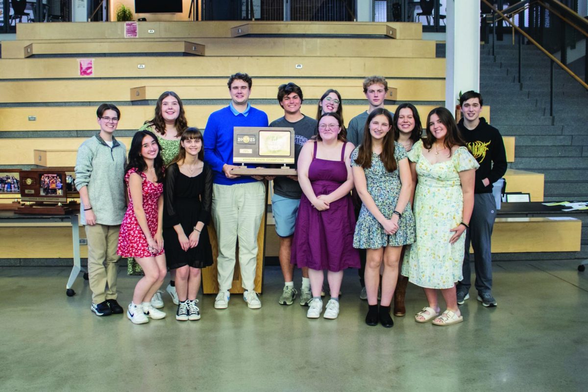 The Forensics State team poses with the state championship trophy. Photo collected by Eli Roust