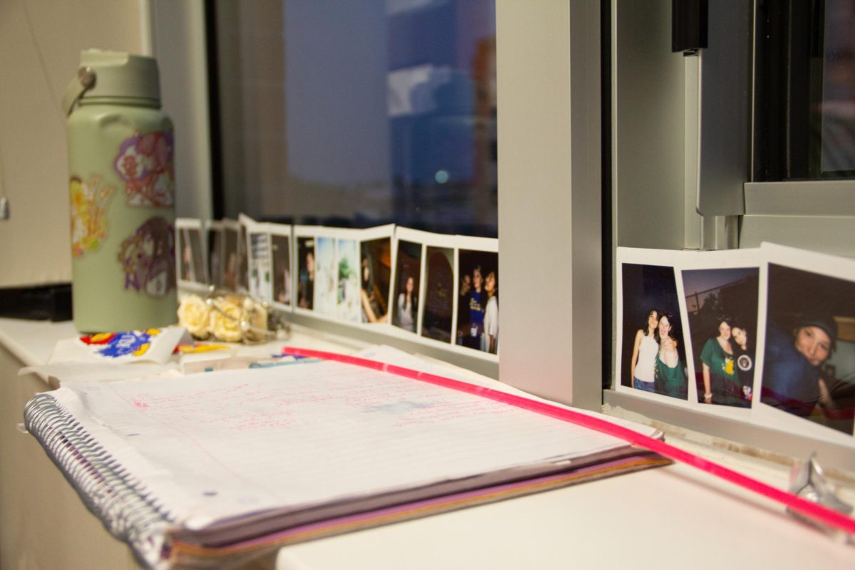 Displayed in the window sill, senior Evie Chancy's polaroids from Jayhawk Media Workshop stay in her dorm.