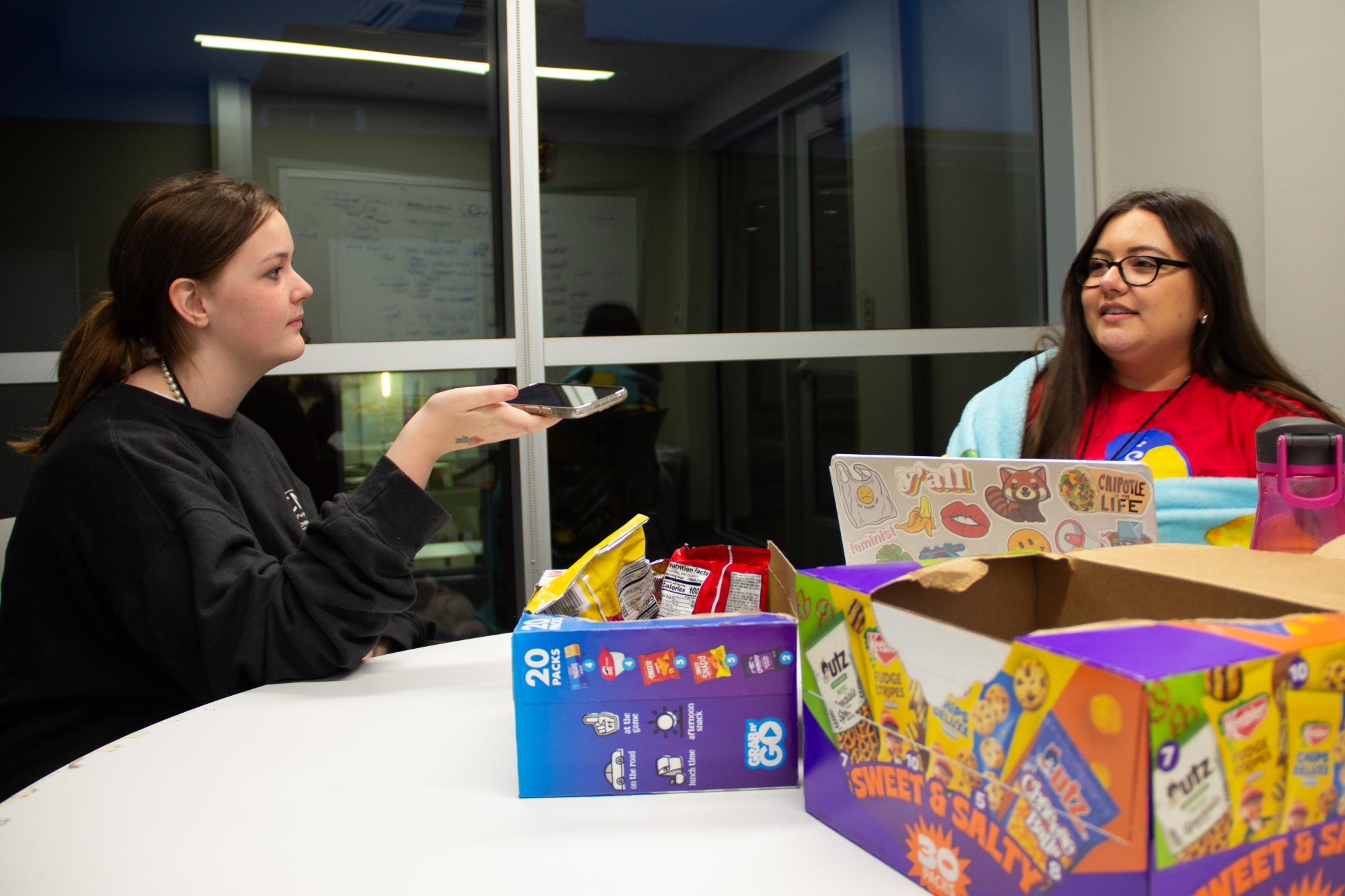 In an interview, senior Evie Chancy talks to a residential assistant. Because Jayhawk Media Workshop has a lot of work, many participants create media while in the dorms.